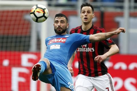 Napoli's Elseid Hysaj, foreground, challenges for the ball with AC Milan's Nikola Kalinic during the Serie A soccer match between AC Milan and Napoli at the San Siro stadium in Milan, Italy, Sunday, April 15, 2018. (AP Photo/Antonio Calanni)