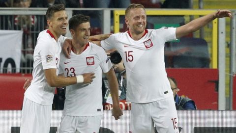 Polish players Kamil Glik, right, and Jan Bednarek, left, celebrate with Poland's Krzysztof Piatek, center, who scored his side's first goal during the UEFA Nations League soccer match between Poland and Portugal at the Silesian Stadium Chorzow, Poland, Thursday Oct. 11, 2018. (AP Photo/Czarek Sokolowski)