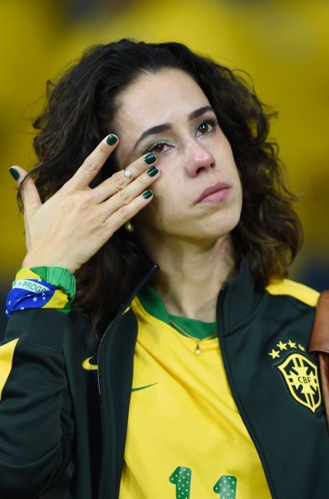 BELO HORIZONTE, BRAZIL - JULY 08:  An emotional Brazil fan reacts after being defeated by Germany 7-1 during the 2014 FIFA World Cup Brazil Semi Final match between Brazil and Germany at Estadio Mineirao on July 8, 2014 in Belo Horizonte, Brazil.  (Photo by Laurence Griffiths/Getty Images)