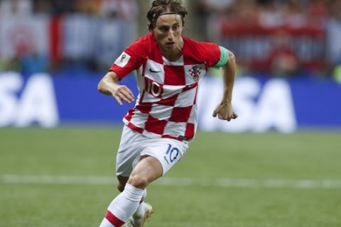 Croatia's Luka Modric runs with the ball during the final match between France and Croatia at the 2018 soccer World Cup in the Luzhniki Stadium in Moscow, Russia, Sunday, July 15, 2018. (AP Photo/Petr David Josek)