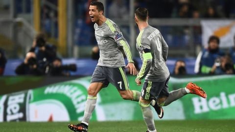 Real Madrid's Portuguese forward Cristiano Ronaldo (L) celebrates with teammate Real Madrid's defender Sergio Ramos after scoring during the UEFA Champions League football match AS Roma vs Real Madrid on Frebruary 17, 2016 at the Olympic stadium in Rome.      AFP PHOTO / FILIPPO MONTEFORTE / AFP / FILIPPO MONTEFORTE        (Photo credit should read FILIPPO MONTEFORTE/AFP/Getty Images)