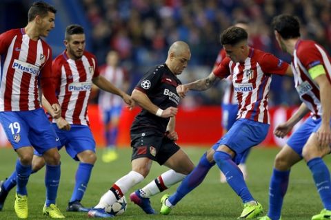 Atletico's Lucas Hernandez, left, Koke, 2nd left, Diego Godin, right, and Jose Maria Gimenez, 2nd right, challenge for the ball with Leverkusen's Javier Hernandez, center during the Champions League round of 16 second leg soccer match between Atletico Madrid and Bayer 04 Leverkusen in Madrid, Spain, Wednesday, March 15, 2017. (AP Photo/Francisco Seco)
