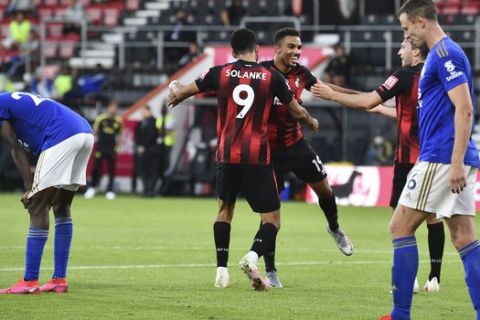 Bournemouth's Junior Stanislas, centre, celebrates with teammates after their third goal during the English Premier League soccer match between Bournemouth and Leicester City at Vitality Stadium in Bournemouth, England, Sunday, July 12, 2020. (AP Photo/Glynn Kirk,Pool)