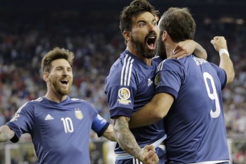 Argentina's Gonzalo Higuain (9) celebrates his goal against the United States with Lionel Messi, left, and Ezequiel Lavezzi, center, during a Copa America Centenario soccer semifinal, Tuesday, June 21, 2016, in Houston. Argentina won 4-0. (AP Photo/Eric Gay)