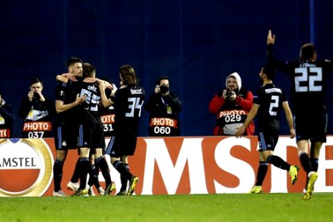 Dinamo Zagreb's Mislav Orsic, second left, celebrates with teammates after scoring his side's opening goal during the Europa League round of 32 second leg soccer match between Dinamo Zagreb and Viktoria Plzen at Maksimir Stadium in Zagreb, Croatia, Thursday, Feb. 21, 2019. (AP Photo/Darko Bandic)