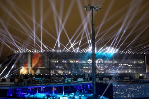 Projectors illuminate the sky during the Act I of The Contemporary Myth of Kaunas Trilogy, "The Confusion", on the river Nemunas island, near Zalgirio Arena during the opening ceremony of the European Capital of Culture in Kaunas, Lithuania, Saturday, Jan. 22, 2022. Kaunas became European Capital of Culture on January 22 with two other cities: Novi Sad (Serbia) and Esch-sur-Alzette (Luxembourg) after a yearlong delay caused by the coronavirus pandemic. (AP Photo/Mindaugas Kulbis)