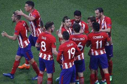 Atletico players celebrate teammate Antoine Griezmann's opening goal during the Europa League Final soccer match between Marseille and Atletico Madrid at the Stade de Lyon outside Lyon, France, Wednesday, May 16, 2018. (AP Photo/Christophe Ena)