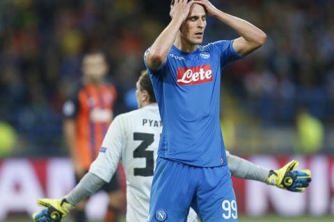 Napoli's Arkadiusz Milik reacts after missing a scoring chance during the Group F Champions League soccer match between Shakhtar Donetsk and Napoli at the Metalist Stadium in Kharkiv, Ukraine, Wednesday, Sept. 13, 2017. (AP Photo/Efrem Lukatsky)