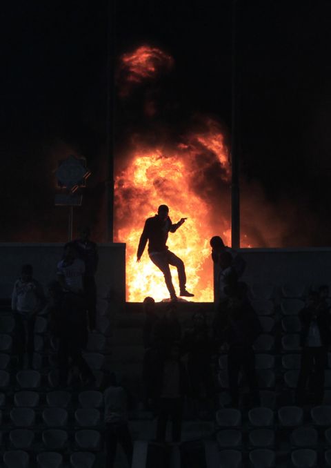 TOPSHOTS
Flames rise from Cairo Stadium during the first half of a match between Zamalek and Ismaili clubs in Cairo on February 1, 2012.  At least 73 people were killed in fan violence after a football match between Al-Ahly and Al-Masry clubs in the city of Port Said, the health ministry said, as Egypt struggled with a wave of incidents linked to poor security. TOPSHOTS/AFP PHOTO/MAHMUD HAMS (Photo credit should read MAHMUD HAMS/AFP/Getty Images)