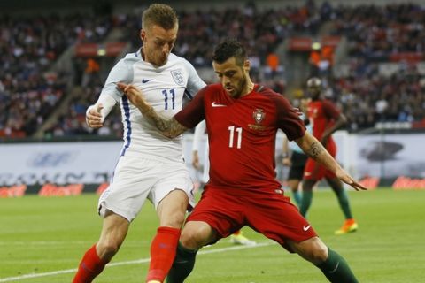 England's Jamie Vardy, left, competes for the ball with Portugal's Vieirinha during the international friendly soccer match between England and Portugal at Wembley stadium in London, Thursday, June 2, 2016. (AP Photo/Kirsty Wigglesworth)
