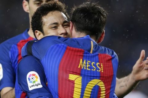 FC Barcelona's Lionel Messi, front, embraces his teammate Neymar after scoring during the Spanish La Liga soccer match between FC Barcelona and Sevilla at the Camp Nou stadium in Barcelona, Spain, Wednesday, April 5, 2017. (AP Photo/Manu Fernandez)