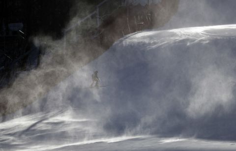 A course worker is shrouded in snow as it blows across the course where the technical events will be held before an inspection by competitors in the women's giant slalom at the Yongpyong Alpine Center at the 2018 Winter Olympics in Pyeongchang, South Korea, Sunday, Feb. 11, 2018. The men's downhill at nearby Jeongseon alpine venue was postponed Sunday due to high winds. (AP Photo/Michael Probst)