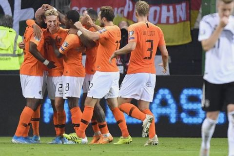 Netherlands' Frenkie de Jong, 2nd left, celebrates after scoring his side's first goal during the Euro 2020 group C qualifying soccer match between Germany and the Netherlands at the Volksparkstadion in Hamburg, Germany, Friday, Sept. 6, 2019. (AP Photo/Martin Meissner)