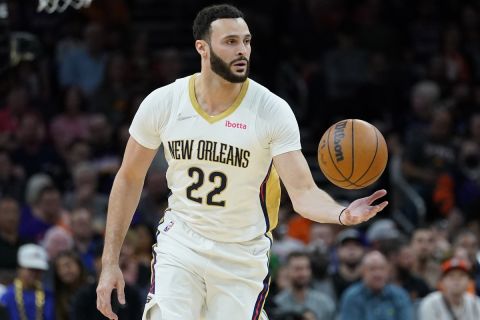 New Orleans Pelicans forward Larry Nance Jr. (22) moves the ball against the Phoenix Suns during the second half of Game 2 of an NBA basketball first-round playoff series, Tuesday, April 19, 2022, in Phoenix. (AP Photo/Matt York)