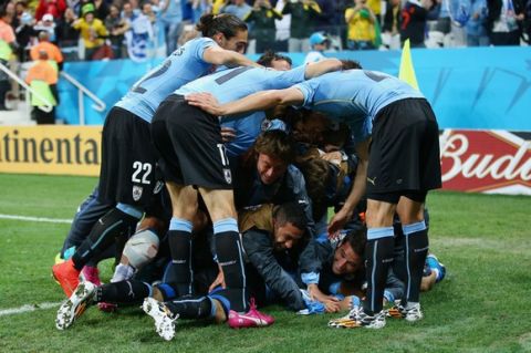 SAO PAULO, BRAZIL - JUNE 19:  Luis Suarez of Uruguay celebrates with his teammates after scoring his team's second goal during the 2014 FIFA World Cup Brazil Group D match between Uruguay and England at Arena de Sao Paulo on June 19, 2014 in Sao Paulo, Brazil.  (Photo by Julian Finney/Getty Images)