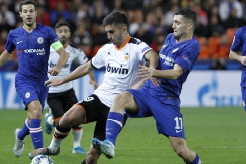 Valencia's Thierry Correia, left, and Chelsea's Mateo Kovacic challenge for the ball during the Champions League group H soccer match between Valencia and Chelsea at the Mestalla stadium in Valencia, Spain, Wednesday, Nov. 27, 2019. (AP Photo/Alberto Saiz)