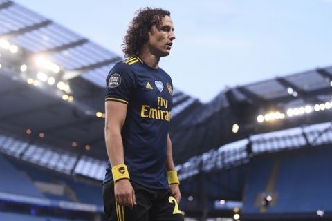 Arsenal's David Luiz leaves the field after getting a red card during the English Premier League soccer match between Manchester City and Arsenal at the Etihad Stadium in Manchester, England, Wednesday, June 17, 2020. The English Premier League resumes Wednesday after its three-month suspension because of the coronavirus outbreak. (Laurence Griffiths/Pool via AP)