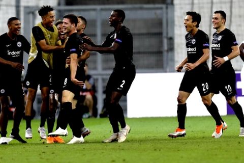 Eintracht Frankfurt's Luka Jovic, third left, reacts with teammates after scoring his side second goal during the Europa League, group H soccer match between Marseille and Eintracht Frankfurt played behind closed doors at the Velodrome stadium in Marseille, southern France, Thursday Sept. 20, 2018. (AP Photo/Claude Paris)