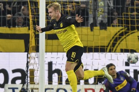 Dortmund's Julian Brandt, left, celebrates after scoring his decisive second goal against Moenchengladbach's goalkeeper Yann Sommer during the German soccer cup, DFB Pokal, second Round match between Borussia Dortmund and Borussia Moenchengladbach in Dortmund, Germany, Wednesday, Oct. 30, 2019. (AP Photo/Martin Meissner)