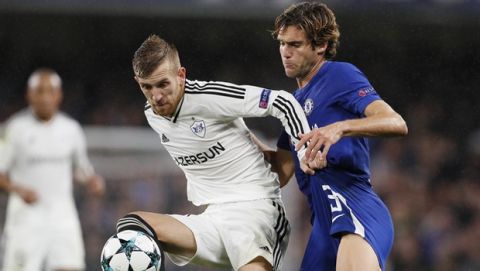 Qarabag's Pedro Henrique, left, challenges for the ball with Chelsea's Marcos Alonso during the Champions League group C soccer match between Chelsea and Qarabag at Stamford Bridge stadium in London, Tuesday, Sept. 12, 2017. (AP Photo/Kirsty Wigglesworth)