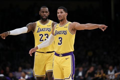 Los Angeles Lakers guard Josh Hart and forward LeBron James point during free throws by the Sacramento Kings during the first half of an NBA preseason basketball game in Los Angeles, Thursday, Oct. 4, 2018. (AP Photo/Kelvin Kuo)