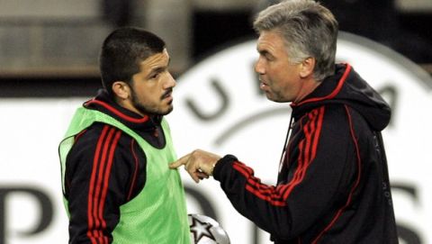 AC Milan coach Carlo Ancelotti, right, points at player Ivan Gattuso Gennaro during a training session ahead of the match against Belgium's Anderlecht in group H of the Champions League at the Constant Vanden Stock stadium in Brussels, Monday Oct. 16, 2006. AC Milan coach Carlo Ancelotti isn't worried that his team has only scored one goal in four Serie A games ahead of Tuesday's Champions League match against Anderlecht. (AP Photo/Yves Logghe)