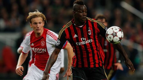 AMSTERDAM, NETHERLANDS - OCTOBER 01:  Christian Poulsen of Ajax is beaten to the ball by Mario Balotelli of AC Milan during the UEFA Champions League Group H match between Ajax Amsterdam and AC Milan at Amsterdam Arena on October 1, 2013 in Amsterdam, Netherlands.  (Photo by Dean Mouhtaropoulos/Getty Images)