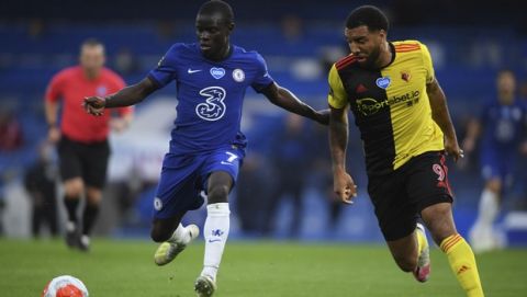 Chelsea's N'Golo Kante, left, fights for the ball with Watford's Troy Deeney during the English Premier League soccer match between Chelsea and Watford at the Stamford Bridge stadium in London, Saturday, July 4, 2020. (Mike Hewitt/Pool via AP)