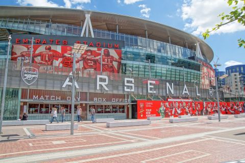 London, UK - June 8, 2014 : Emirates Stadium, North London, home of English Premier League team Arsenal Football Club. View shows the south entrance and club shop with box office. People are walking along the concourse area.