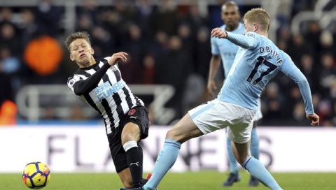 Newcastle United's Dwight Gayle, left, and Manchester City's Kevin De Bruyne battle for the ball during their English Premier League soccer match at St James' Park, Newcastle, England, Wednesday, Dec. 27, 2017. (Owen Humphreys/PA via AP)