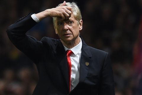 Arsenals manager Arsene Wenger looks across the pitch during the English Premier League soccer match between Arsenal and Manchester United at the Emirates Stadium, London, Saturday, Nov. 22, 2014. (AP Photo/Tim Ireland)