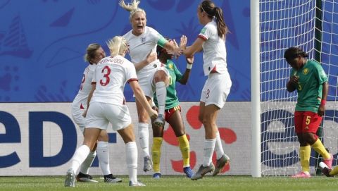 England's Steph Houghton, third from left, celebrates with teammates after scoring her side's first goal during the Women's World Cup round of 16 soccer match between England and Cameroon at the Stade du Hainaut stadium in Valenciennes, France, Sunday, June 23, 2019. (AP Photo/Michel Spingler)