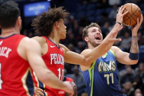 Dallas Mavericks forward Luka Doncic (77) drives to the basket against h10= and guard JJ Redick (4) in the first half of an NBA basketball game in New Orleans, Tuesday, Dec. 3, 2019. The Mavericks won 118-97. (AP Photo/Gerald Herbert)