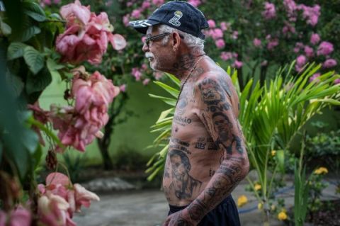TO GO WITH AFP STORY by Javier Tovar
Brazilian football club Botafogo fan Delneri Martins Viana, a 69-year-old retired soldier, relaxes at his home in Rio de Janeiro, Brazil, on January 18, 2014. Delneri has 83 tattoos on his body dedicated to Botafogo and describes himself as the club's biggest fan.   AFP PHOTO / YASUYOSHI CHIBA