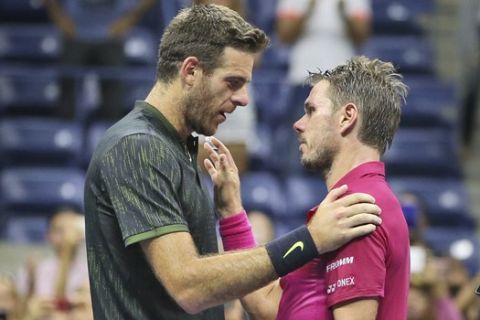 Stan Wawrinka, right, of Switzerland, right, and Juan Martin del Potro, of Argentina, meet at the net after Wawrinka's 7-6 (5), 4-6, 6-3, 6-2 win in the quarterfinals of the U.S. Open tennis tournament, early Thursday, Sept. 8, 2016, in New York. (AP Photo/Seth Wenig)