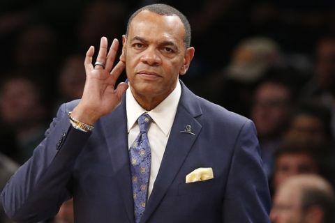 Brooklyn Nets head coach Lionel Hollins puts his hand to his ear in the second half of an NBA basketball game, Monday, Jan. 4, 2016, in New York. The Celtics defeated the Nets 103-94. (AP Photo/Kathy Willens)
