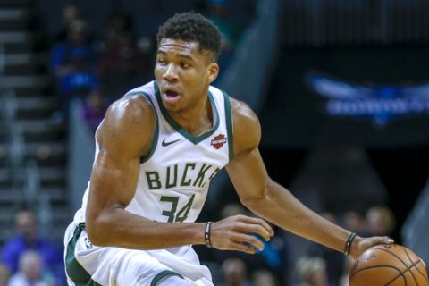 Milwaukee Bucks forward Giannis Antetokounmpo, of Greece, in action against the Charlotte Hornets in the first half of an NBA basketball game in Charlotte, N.C., Monday, Nov. 26, 2018. Charlotte won 110-107. (AP Photo/Nell Redmond)