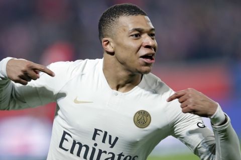 FILE - In this April 14, 2019 file photo, PSG's Kylian Mbappe celebrates after his team scored during the French League One soccer match between OSC Lille and Paris Saint-Germain at Stade Pierre Mauroy in Lille, France. After lifting the World Cup with France last summer, Mbappe now wants to win the European championships and a gold medal at the Tokyo Olympics next year. (AP Photo/Christophe Ena, File)