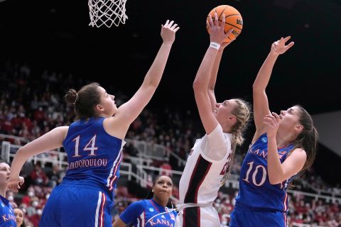 Stanford forward Cameron Brink, center, shoots against Kansas center Danai Papadopoulou (14) and Ioanna Chatzileonti (10) during the second half of a second-round game in the NCAA women's college basketball tournament Sunday, March 20, 2022, in Stanford, Calif. (AP Photo/Tony Avelar)