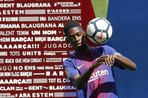 French soccer player Ousmane Dembele controls the ball during official presentation at the Camp Nou stadium in Barcelona, Spain, Monday, Aug. 28, 2017. Barcelona is shoring up its attack following Neymar's departure by buying Ousmane Dembele from Borussia Dortmund in a deal that could reach 147 million euros (about US dollars 173 million). (AP Photo/Manu Fernandez)