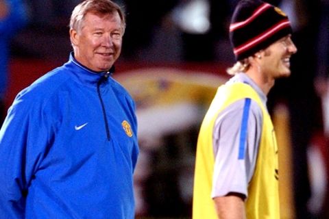 FILE - This is a Tuesday Oct. 22, 2002 file photo of Manchester's United coach Sir Alex Ferguson, left, as he speaks with  David Beckham during a training session for Wednesday's Group F soccer match in the Champions League against Olympiakos Piraeus in Athens . David Beckham is retiring from soccer after the season, ending a career in which he become a global superstar since starting his career at Manchester United. The 38-year-old Englishman recently won a league title in a fourth country with Paris Saint-Germain. He said in a statement Thursday May 16, 2013 he is "thankful to PSG for giving me the opportunity to continue but I feel now is the right time to finish my career, playing at the highest level."  (AP Photo/Aris Messinis, File)