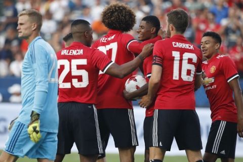 Manchester United players celebrate a goal by Marcus Rashford, third from right, as Los Angeles Galaxy goalkeeper Jon Kempin, left, walks past during the first half of a friendly soccer match Saturday, July 15, 2017, in Carson, Calif. (AP Photo/Jae C. Hong)