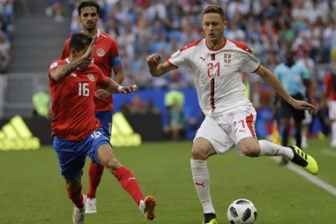 Serbia's Nemanja Matic, right, vies for the ball with Costa Rica's Cristian Gamboa during the group E match between Costa Rica and Serbia at the 2018 soccer World Cup in the Samara Arena in Samara, Russia, Sunday, June 17, 2018. (AP Photo/Natacha Pisarenko)