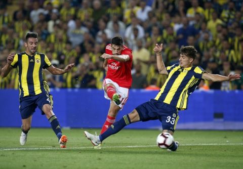 Benfica's Pizzi attempts a shot at goal between Fenerbahce's Mauricio Isla, left, and Roman Neustadter, right, during the Champions League third qualifying round, second leg, soccer match between Fenerbahce and Benfica at the Sukru Saracoglu stadium in Istanbul, Tuesday, Aug. 14, 2018. (AP Photo/Lefteris Pitarakis)