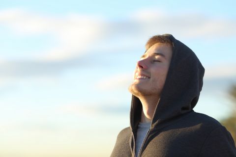 Portrait of a teenage boy breathing deep fresh air