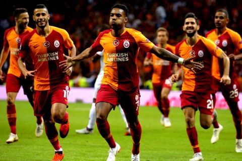 Galatasaray's forward Garry Rodrigues, centre, celebrates after scoring against Lokomotiv Moscow during the Champions League Group D soccer match between Galatasaray and Lokomotiv Moscow in Istanbul, Tuesday, Sept. 18, 2018. (AP Photo)