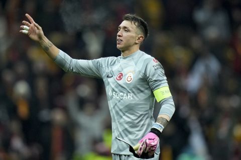 Galatasaray's goalkeeper Fernando Muslera celebrates with supporters at the end of the Europa League play-off first league soccer match between Galatasaray and Sparta Praha in Istanbul, Turkey, Thursday, Feb. 15, 2024. Galatasaray won 3-2. (AP Photo/Francisco Seco)