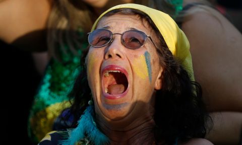 A Brazil soccer fan reacts as Belgium scores during a live telecast of the Brazil vs. Belgium World Cup quarter finals soccer match, in Rio de Janeiro, Brazil, Friday, July 6, 2018. (AP Photo/Silvia Izquierdo)