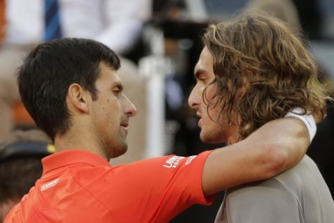 Serbia's Novak Djokovic hugs Greece's Stefanos Tsitsipas after winning the final of the Madrid Open tennis tournament in two sets, 6-3, 6-4, in Madrid, Spain, Sunday, May 12, 2019. (AP Photo/Bernat Armangue)