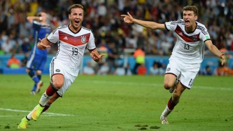 RIO DE JANEIRO, BRAZIL - JULY 13: Mario Goetze of Germany (L) celebrates scoring his team's first goal with Thomas Mueller during the 2014 FIFA World Cup Brazil Final match between Germany and Argentina at Maracana on July 13, 2014 in Rio de Janeiro, Brazil.  (Photo by Jamie McDonald/Getty Images)